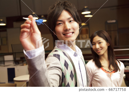 A couple doing darts 66717758