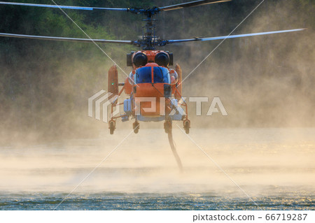 KA-32 Firefighting helicopter is hovering over the KA-32 Firefighting helicopter is hovering over the 66719287