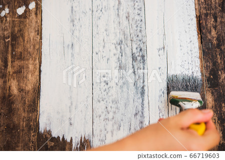 hand using paintbrush decorating or painting old 66719603