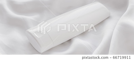 Blank label cosmetic container bottle as product mockup on white silk background 66719911