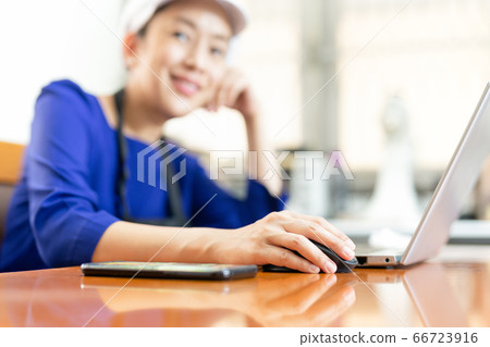 Chef businesswoman smiling at camera while working on laptop at home. Chef businesswoman smiling at camera while working on laptop at home. 66723916