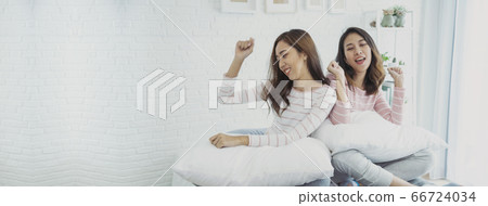 Two young women dance laughing together happy Two young women dance laughing together happy 66724034