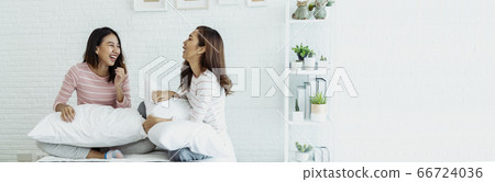 Two young women dance laughing together happy Two young women dance laughing together happy 66724036