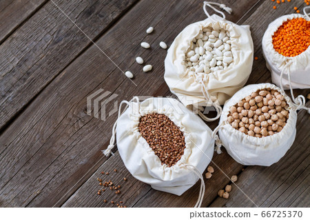 Healthy grains and groats in linen eco bags on wooden table Healthy grains and groats in linen eco bags on wooden table 66725370