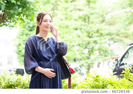 Pregnant woman talking on mobile Pregnant woman talking on mobile 66726536