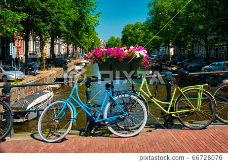 Amsterdam canal with boats and bicycles on a bridge Amsterdam canal with boats and bicycles on a bridge 66728076