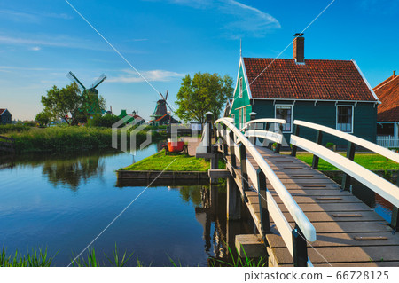 Bridge over canal at windmills at Zaanse Schans in Holland. Zaandam, Netherlands 66728125