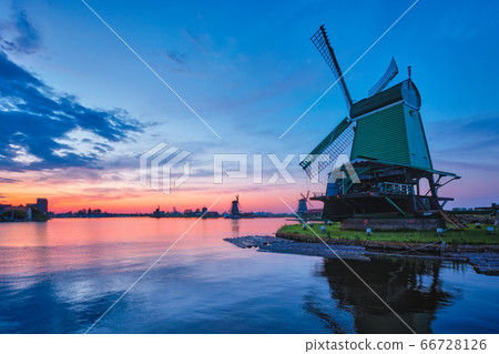 Windmills at famous tourist site Zaanse Schans in Holland with dramatic sky. Zaandam, Netherlands 66728126