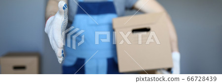 Male hand hold cardboard against new flat closeup 66728439