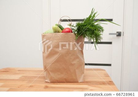 Contactless product delivery by the door. Food donation package vegetables to help the poor. Donat box with foodstuffs 66728961