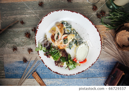Cooked tender chicken breast with spinach Cooked tender chicken breast with spinach 66729337