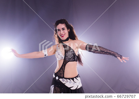 Spirituality dance. Beautiful sexy woman with luxury glossy eastern make-up dancing tribal fusion. Belly dance. Spirituality dance. Beautiful sexy woman with luxury glossy eastern make-up dancing tribal fusion. Belly dance. 66729707