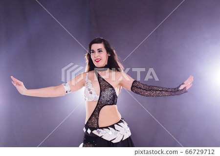 Spirituality dance. Beautiful sexy woman with luxury glossy eastern make-up dancing tribal fusion. Belly dance. Spirituality dance. Beautiful sexy woman with luxury glossy eastern make-up dancing tribal fusion. Belly dance. 66729712
