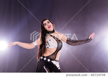 Spirituality dance. Beautiful sexy woman with luxury glossy eastern make-up dancing tribal fusion. Belly dance. Spirituality dance. Beautiful sexy woman with luxury glossy eastern make-up dancing tribal fusion. Belly dance. 66729749