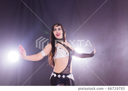 Spirituality dance. Beautiful sexy woman with luxury glossy eastern make-up dancing tribal fusion. Belly dance. Spirituality dance. Beautiful sexy woman with luxury glossy eastern make-up dancing tribal fusion. Belly dance. 66729785