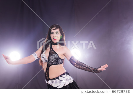 Spirituality dance. Beautiful sexy woman with luxury glossy eastern make-up dancing tribal fusion. Belly dance. Spirituality dance. Beautiful sexy woman with luxury glossy eastern make-up dancing tribal fusion. Belly dance. 66729788