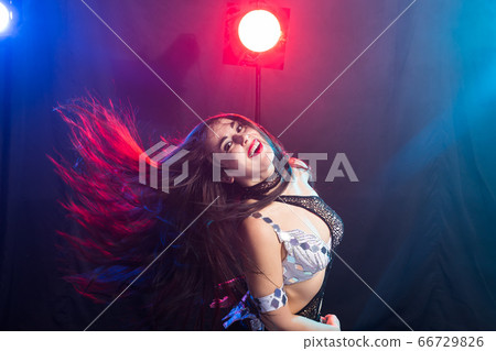 Young woman dancing in Tribal Fusion style. Belly dance on the stage. Young woman dancing in Tribal Fusion style. Belly dance on the stage. 66729826