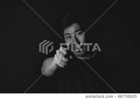 Asian murderer man aiming gun to victim, Suspect preparing to shoot police officer Asian murderer man aiming gun to victim, Suspect preparing to shoot police officer 66730020