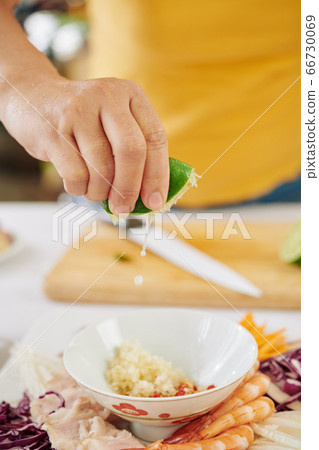 Woman making dipping sauce Woman making dipping sauce 66730069