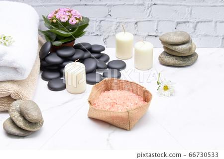 Spa bath salts next to some towels and candles on Spa bath salts next to some towels and candles on 66730533