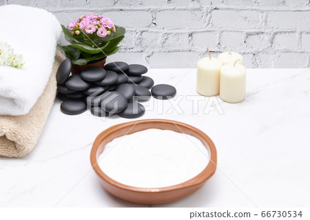 Cosmetic cream together with some towels and some Cosmetic cream together with some towels and some 66730534