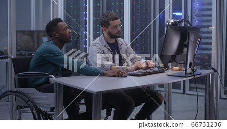 Young programmers working in data center 66731236