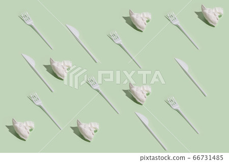 Top view of white plastic forks on pale green background. Trendy isometric pattern with shadows Top view of white plastic forks on pale green background. Trendy isometric pattern with shadows 66731485