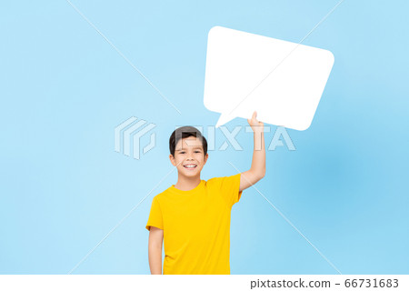 Waist up portrait of smiling cute Asian boy holding speech bubble Waist up portrait of smiling cute Asian boy holding speech bubble 66731683