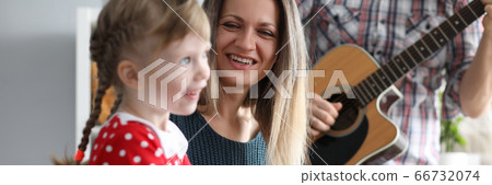 Parents play guitars, daughter on synthesizer Parents play guitars, daughter on synthesizer 66732074