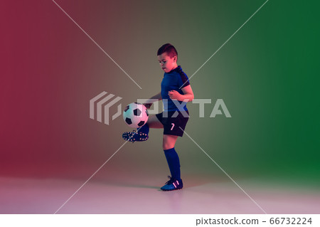 Teen male football or soccer player, boy on gradient background in neon light - motion, action, activity concept 66732224
