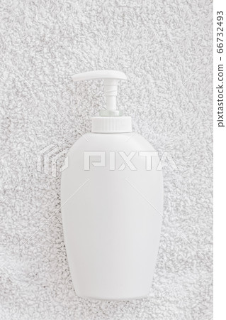 Blank label cosmetic container bottle as product mockup on white towel background Blank label cosmetic container bottle as product mockup on white towel background 66732493