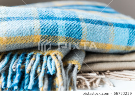 Stack of woolen checked blankets Stack of woolen checked blankets 66733239
