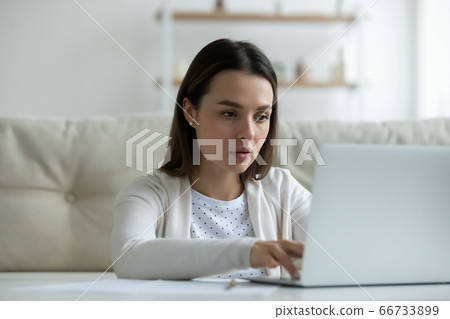 Woman working at home search information typing business message Woman working at home search information typing business message 66733899