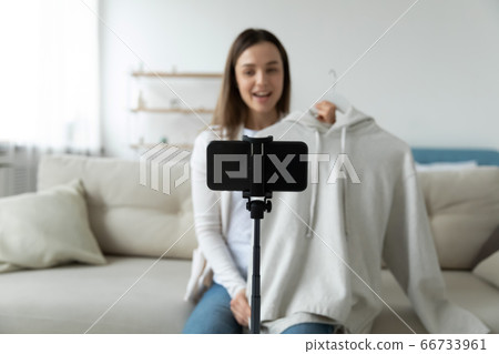 Woman sell clothes via internet using smartphone recording video advertisement 66733961