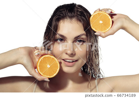 Close up of beautiful young woman over white background. Cosmetics and makeup, natural and eco treatment, skin care. Close up of beautiful young woman over white background. Cosmetics and makeup, natural and eco treatment, skin care. 66734189