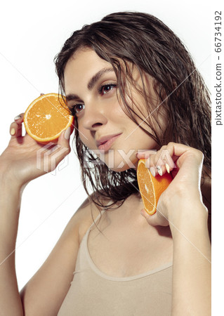Close up of beautiful young woman over white background. Cosmetics and makeup, natural and eco treatment, skin care. Close up of beautiful young woman over white background. Cosmetics and makeup, natural and eco treatment, skin care. 66734192