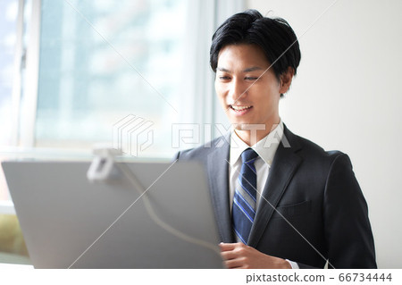 Man in a suit making a video call Man in a suit making a video call 66734444