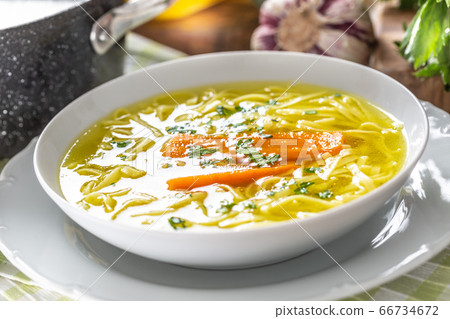 Chicken soup broth in a plate carrot onion celery Chicken soup broth in a plate carrot onion celery 66734672