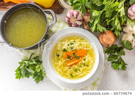 Chicken soup broth in a plate carrot onion celery Chicken soup broth in a plate carrot onion celery 66734674