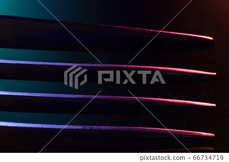 Prongs of one fork in colorful illumination macro Prongs of one fork in colorful illumination macro 66734719