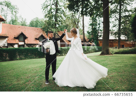 Wedding couple holding hands, groom and bride together on wedding day Wedding couple holding hands, groom and bride together on wedding day 66735655
