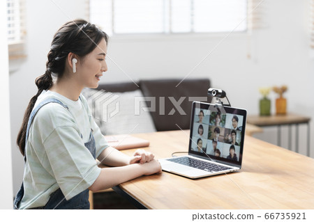 Image of a young female teleworker attending an online meeting 66735921
