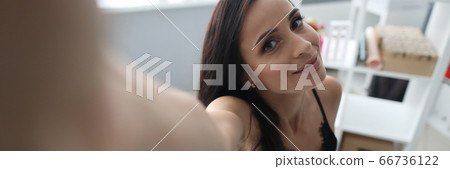 Girl sitting on bed and reaches out to camera Girl sitting on bed and reaches out to camera 66736122
