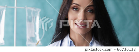 Beautiful woman doctor stand with folder smiling 66736138