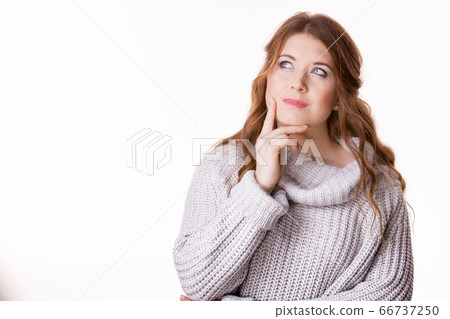 Confused young woman in sweater Confused young woman in sweater 66737250