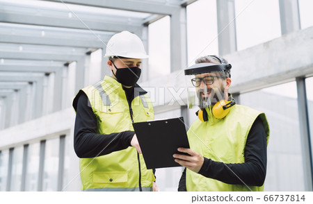 Portrait of workers with face mask at the airport, discussing issues. 66737814
