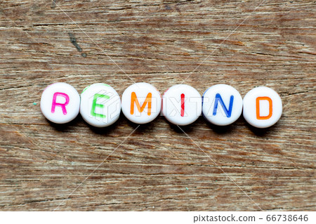 White bead with color letter in word remind on wood background 66738646