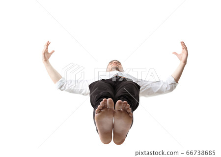 Mid-air beauty. Full length studio shot of attractive young man hovering in air and keeping eyes closed 66738685
