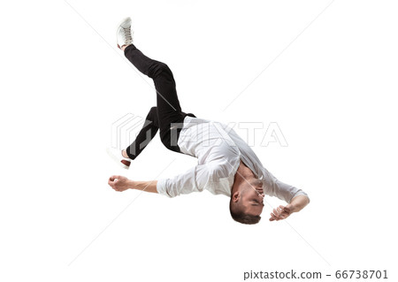 Mid-air beauty. Full length studio shot of attractive young man hovering in air and keeping eyes closed 66738701