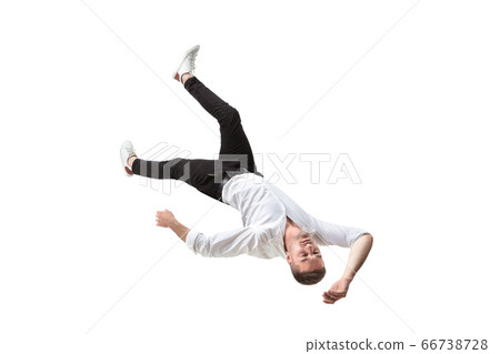 Mid-air beauty. Full length studio shot of attractive young man hovering in air and keeping eyes closed 66738728